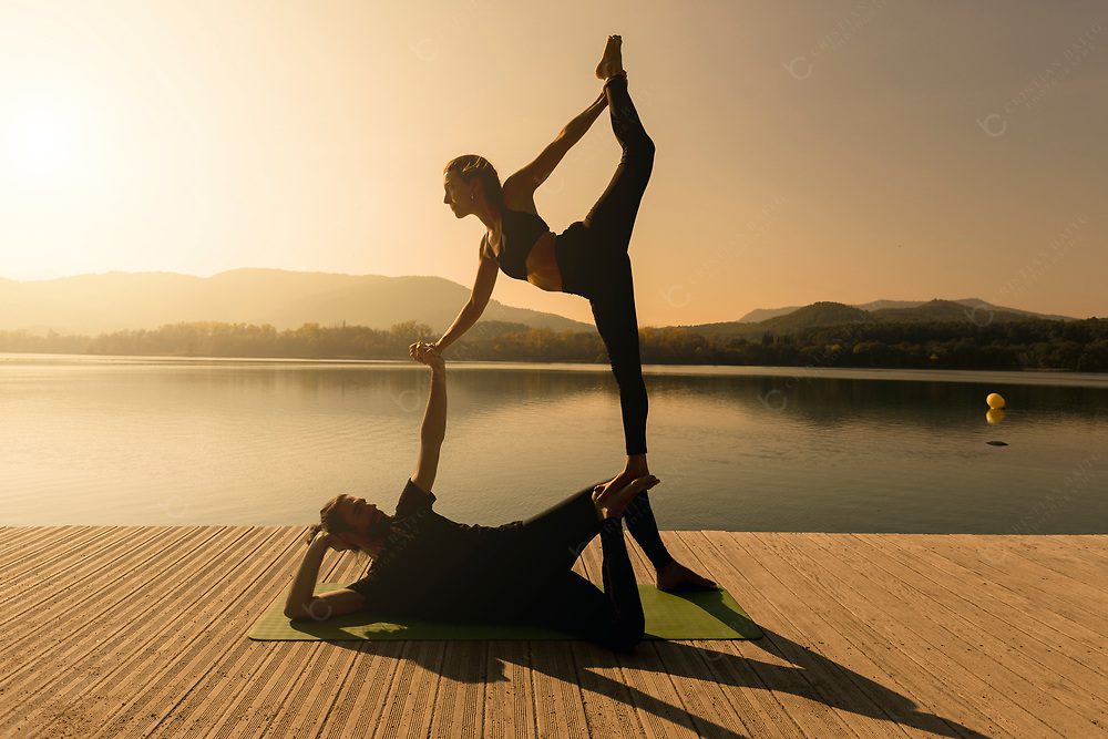 Acroyoga Natarajasana pose at sunset